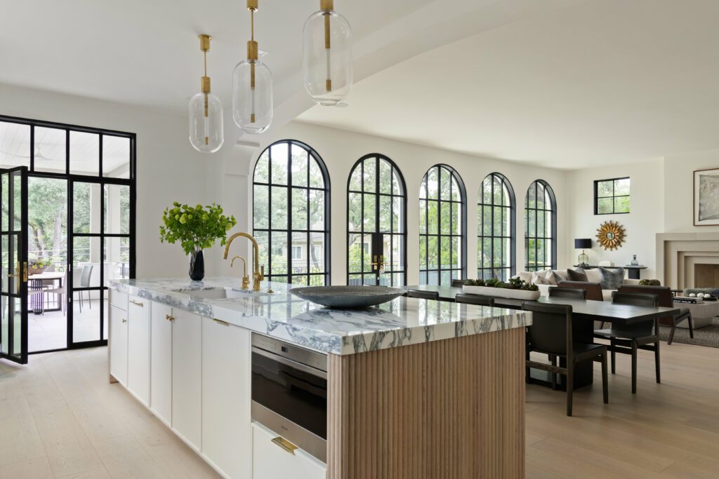 Bright kitchen and dining room with arched windows in an Austin home cleaned by clean+